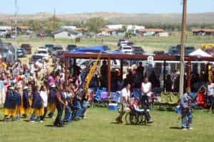 Gilbert Jarvis carries the eagle staff in the Sunday grand entry, while honored veteran and Eastern Shoshone elder Finn Snyder and the American Legion Color Guard follow behind. (Gregory Nickerson/WyoFile)