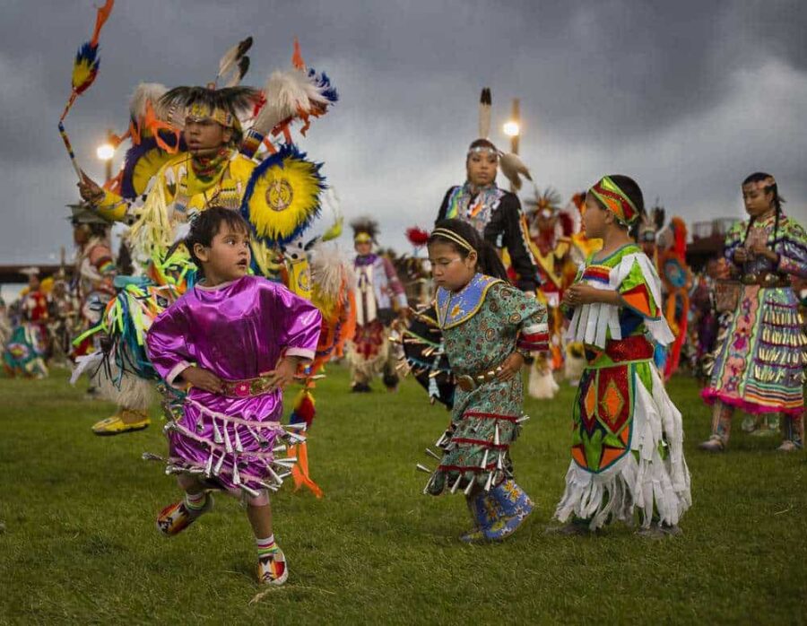 Carmya Sage (girl in pink dress), age 3, dances in the Saturday evening Grand Entry at the Eastern Shoshone Indian Days Powwow (Terance Oldman)